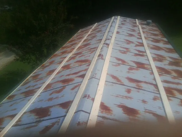 Rusted metal roof panels with new wood purlins before replacement — Storm Damage Roof Repair in Mandan by Roofing Brothers